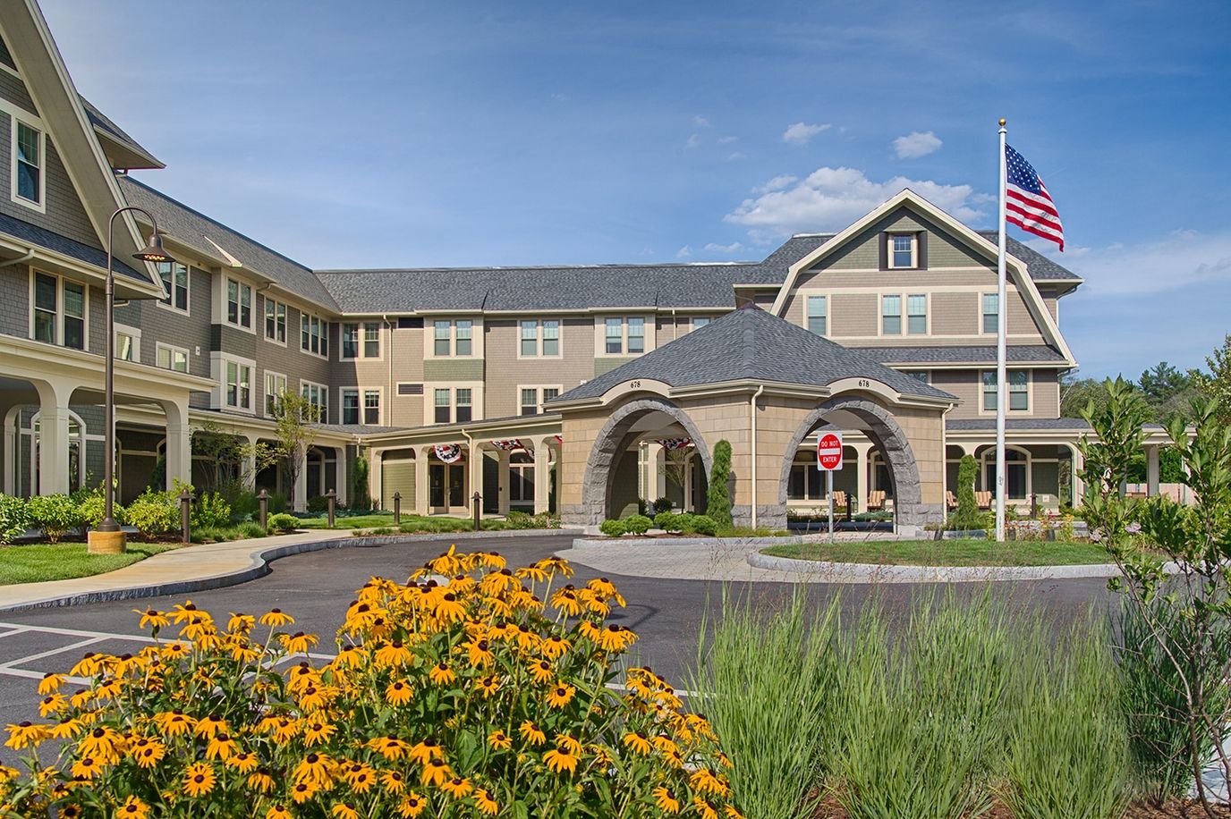Exterior view of assisted living facility with flowers