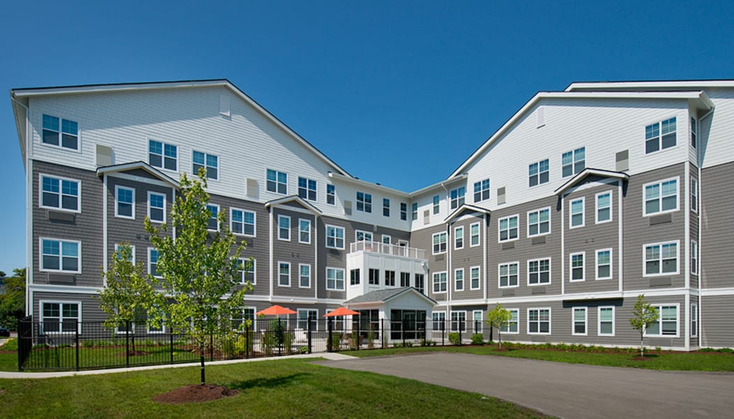 Exterior view of a senior living facility with landscaping