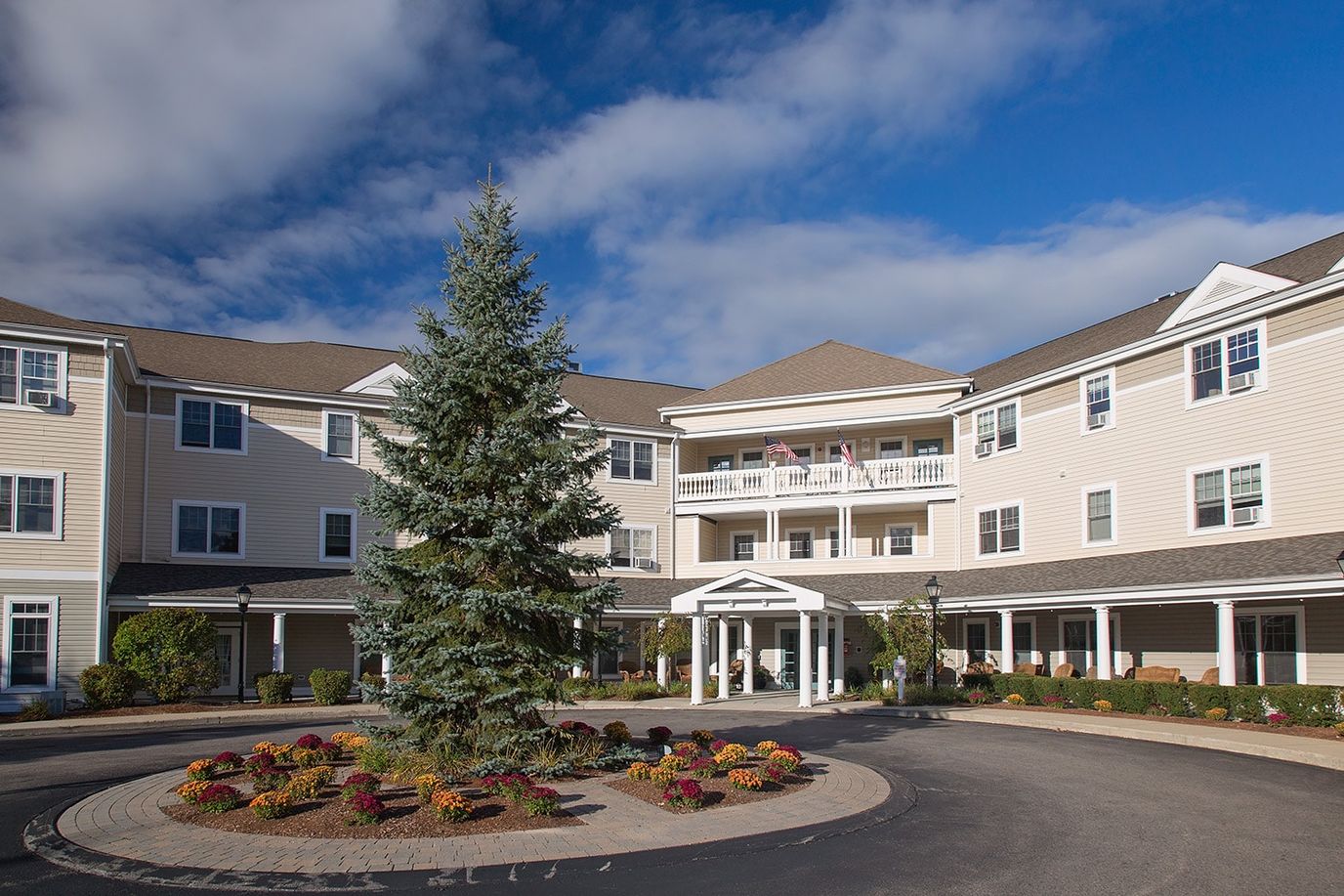 Exterior view of the Traditions of Dedham facility with landscaping