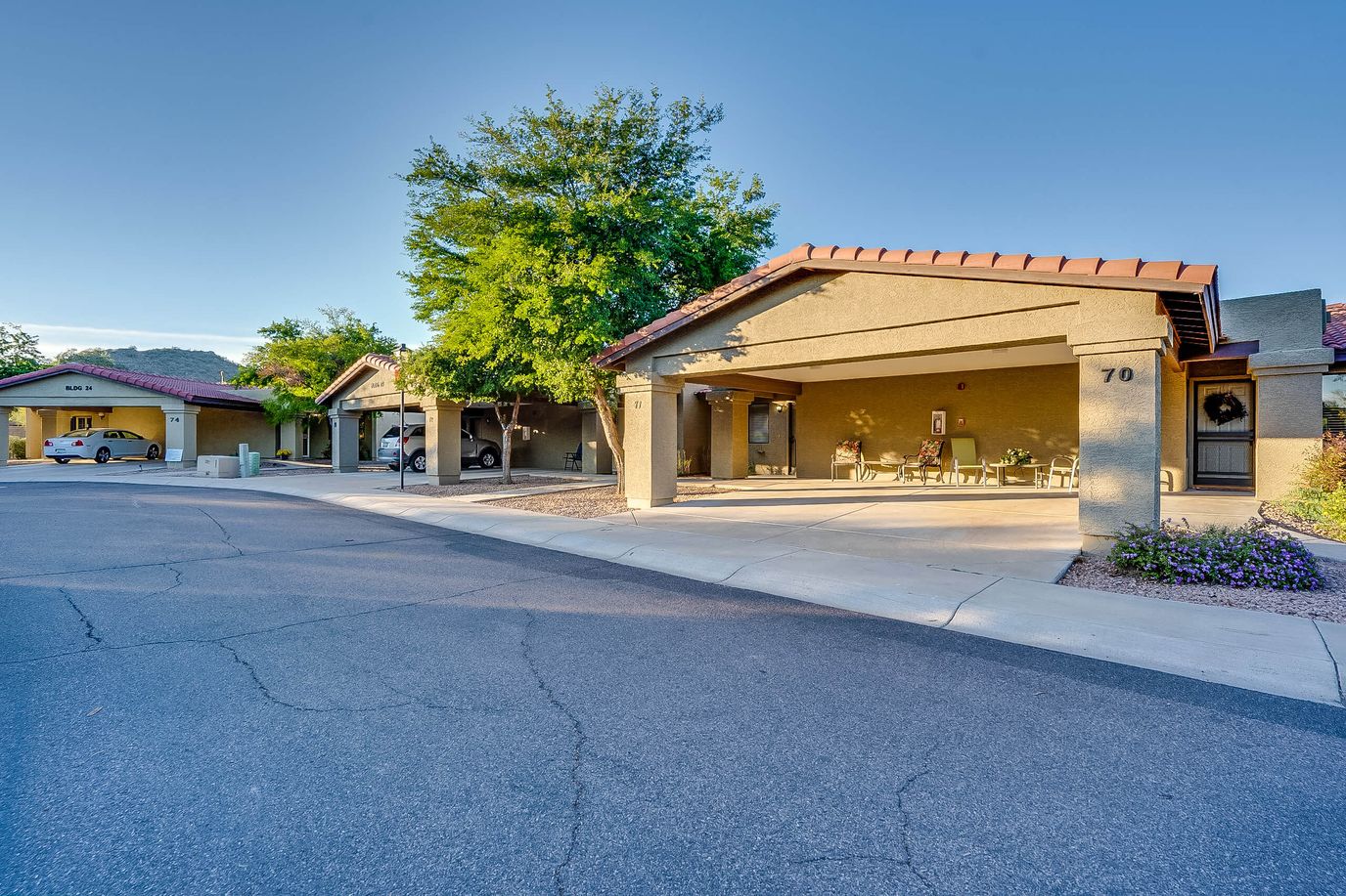 Exterior view of a senior living facility with outdoor seating