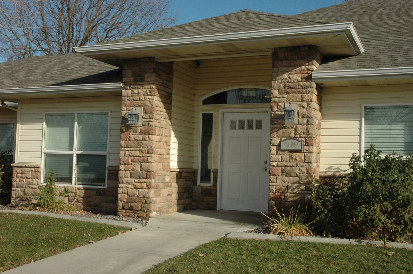 Entrance of Ashley Manor Memory Care Center with stone facade