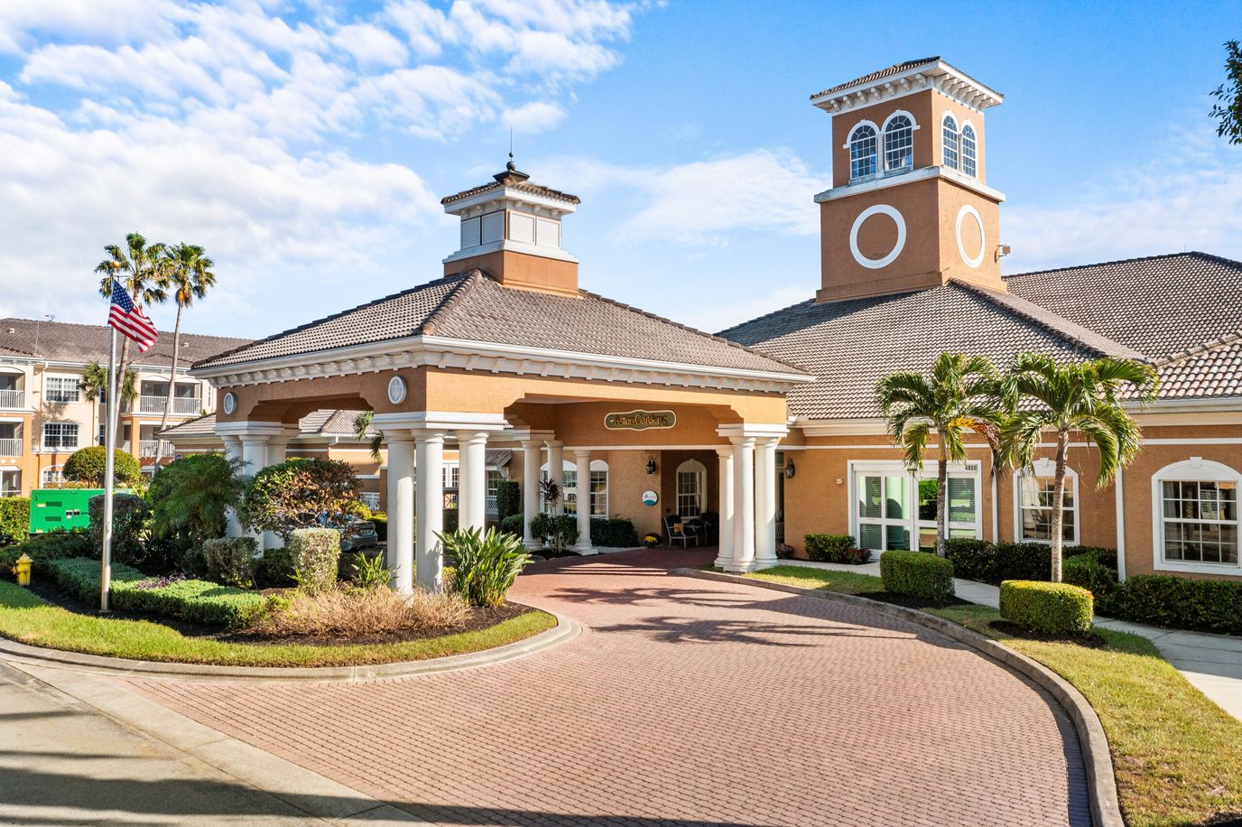Front entrance of a senior living facility with palm trees
