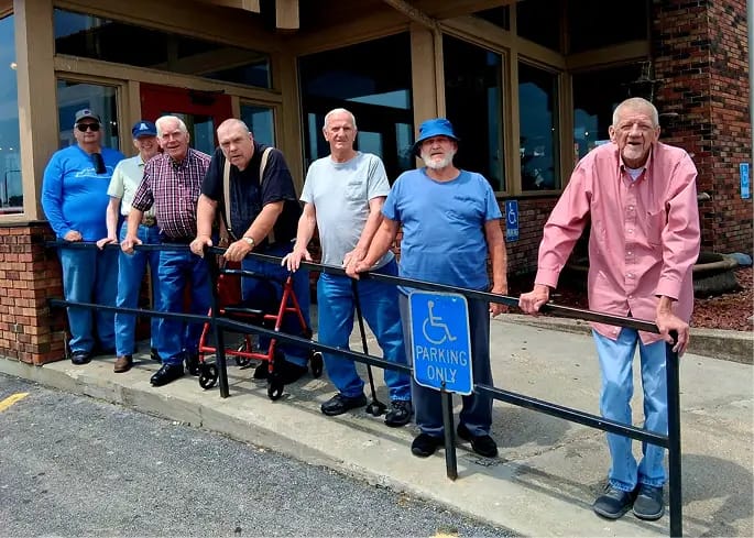 Residents posing outside the facility