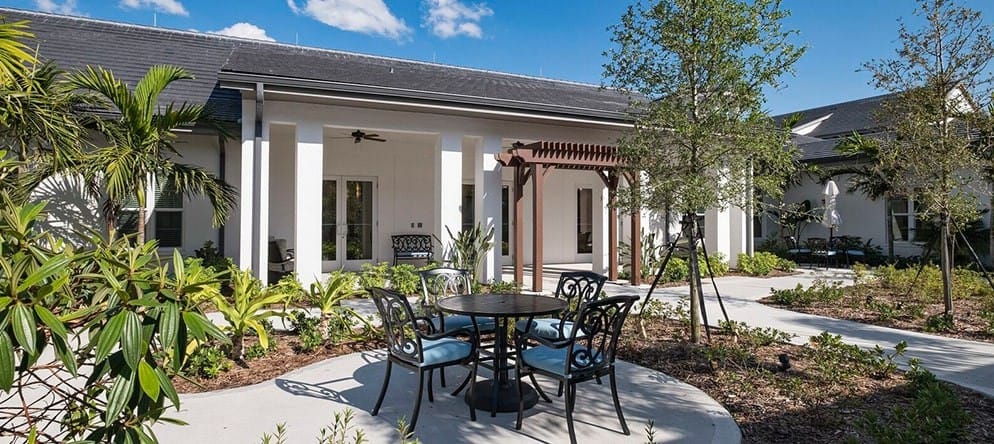 Outdoor seating area with tables and landscaping