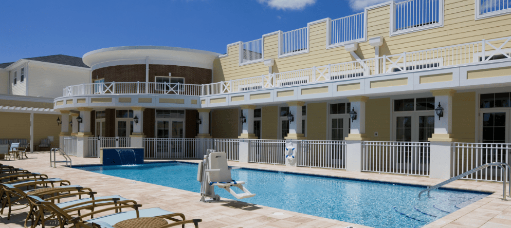 Outdoor pool area with seating and lounge chairs