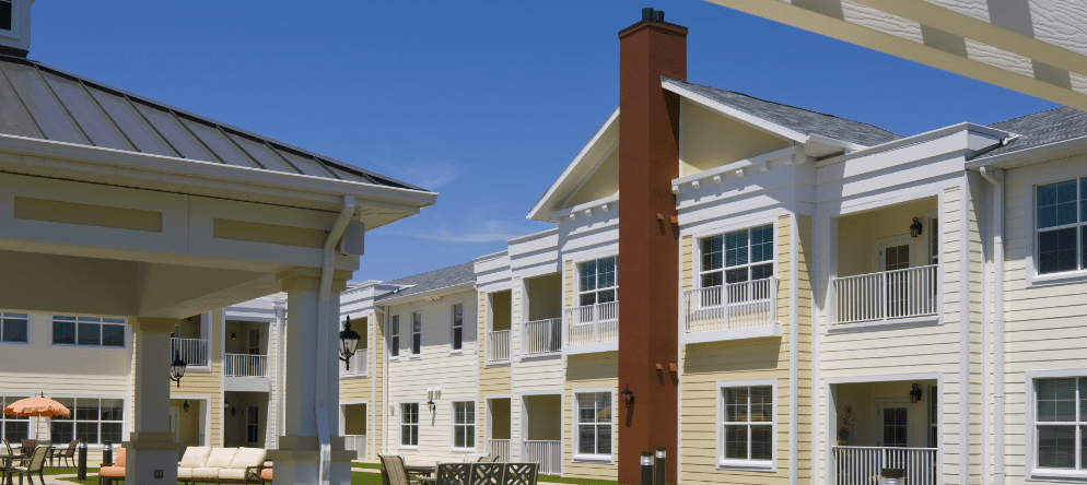 View of the exterior of a senior living facility with outdoor seating