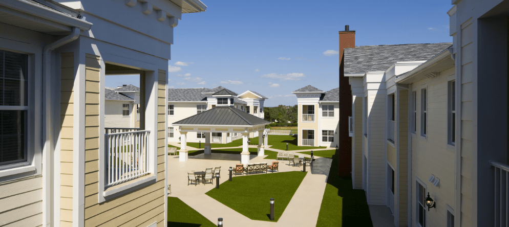 Outdoor seating area with gazebo and landscaped grounds
