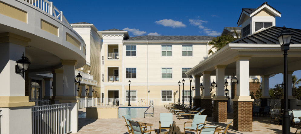 Exterior view of the facility with pool and seating area