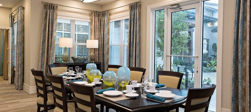 Dining area with table settings and garden view