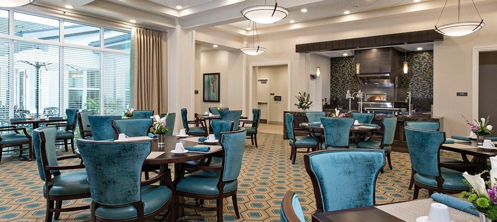 Elegant dining room with teal chairs and tables