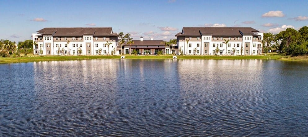 Exterior view of Watercrest St. Lucie West by a lake