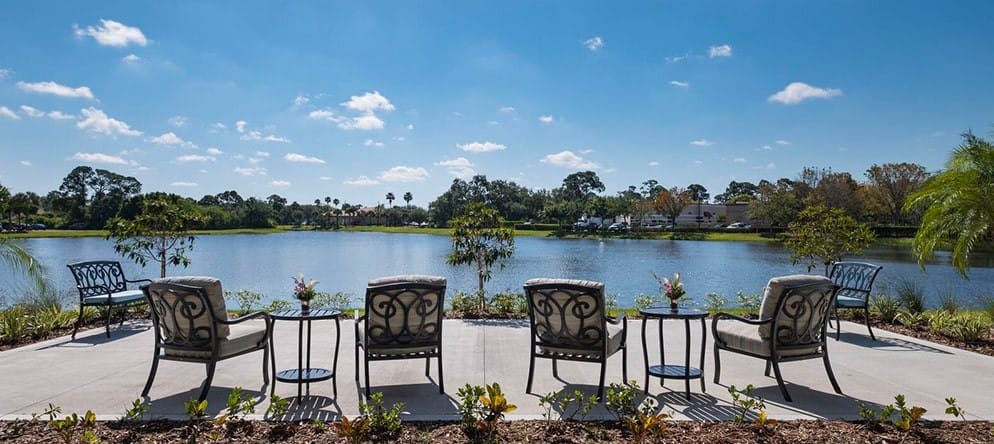 Outdoor seating area overlooking a serene lake