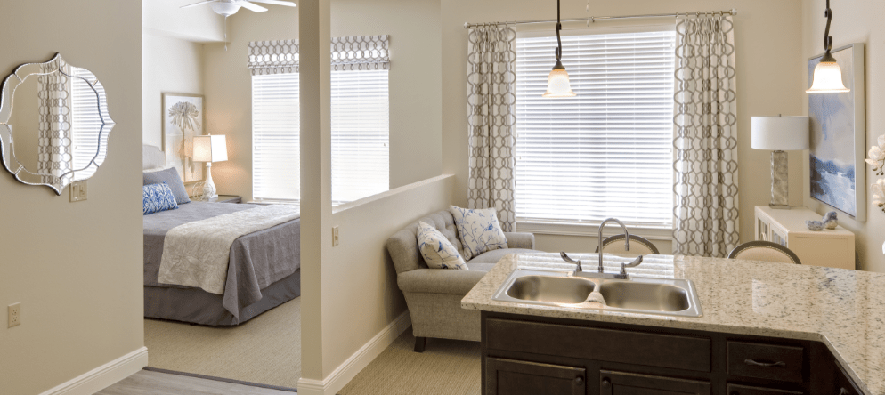 Interior view of a resident's suite with a bedroom and living area