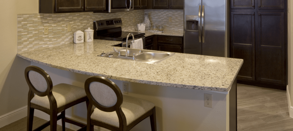 Modern kitchen area with granite countertops
