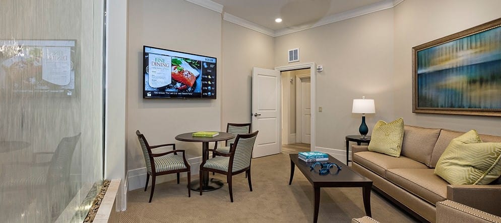 A cozy common area with seating and a TV