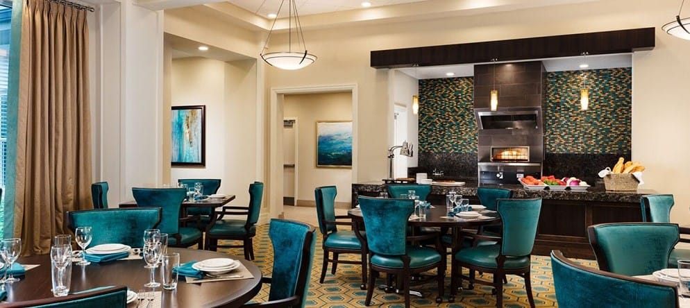 A bright dining room with tables set for meals