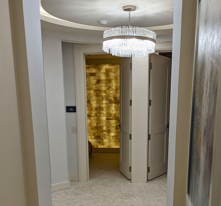 A well-lit interior hallway with a chandelier