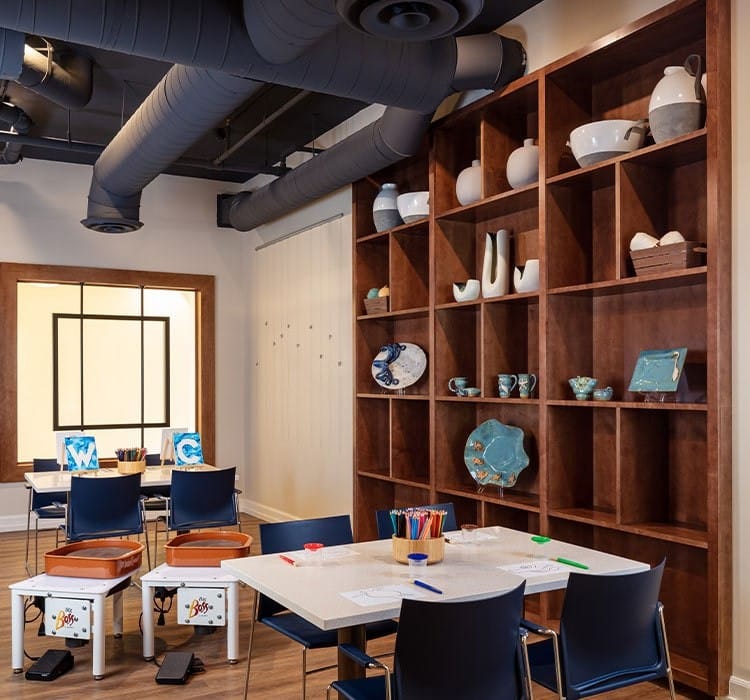 Bright activity room with art supplies and shelving