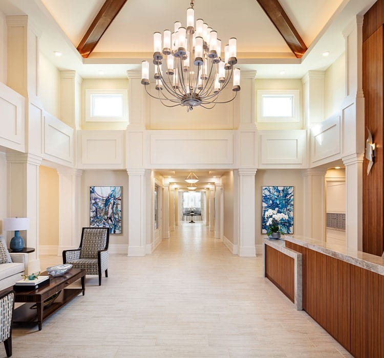 Bright, welcoming lobby area with chandelier and seating
