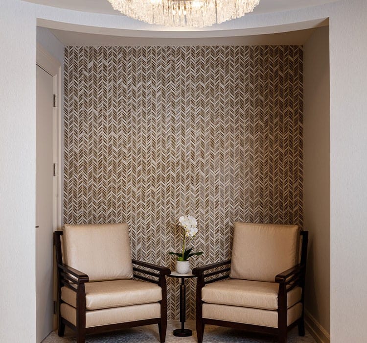Cozy seating area with two chairs and a flower vase