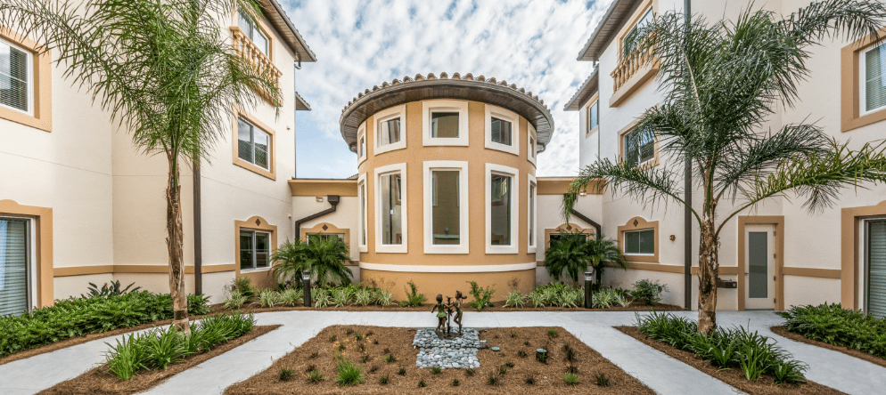 Well-maintained courtyard with palm trees and landscaping