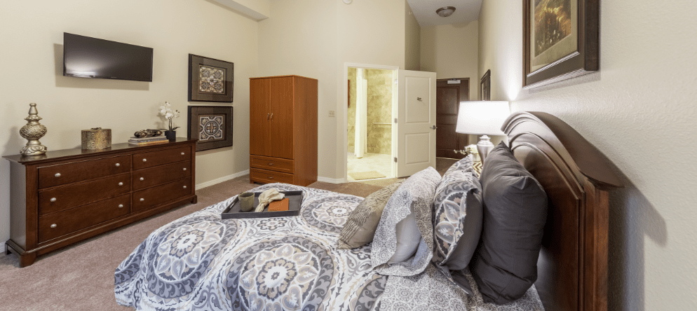 A beautifully decorated resident room with a bed and furniture