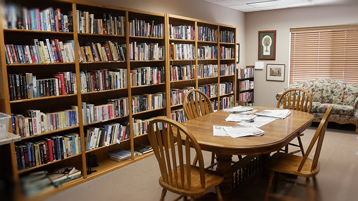 Common area with bookshelves and dining table