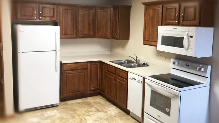 Kitchen area with appliances and cabinetry.