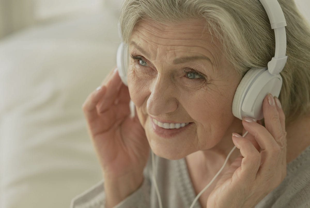 Senior woman enjoying music with headphones