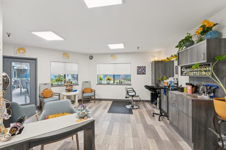 Brightly lit salon area with seating and decor.