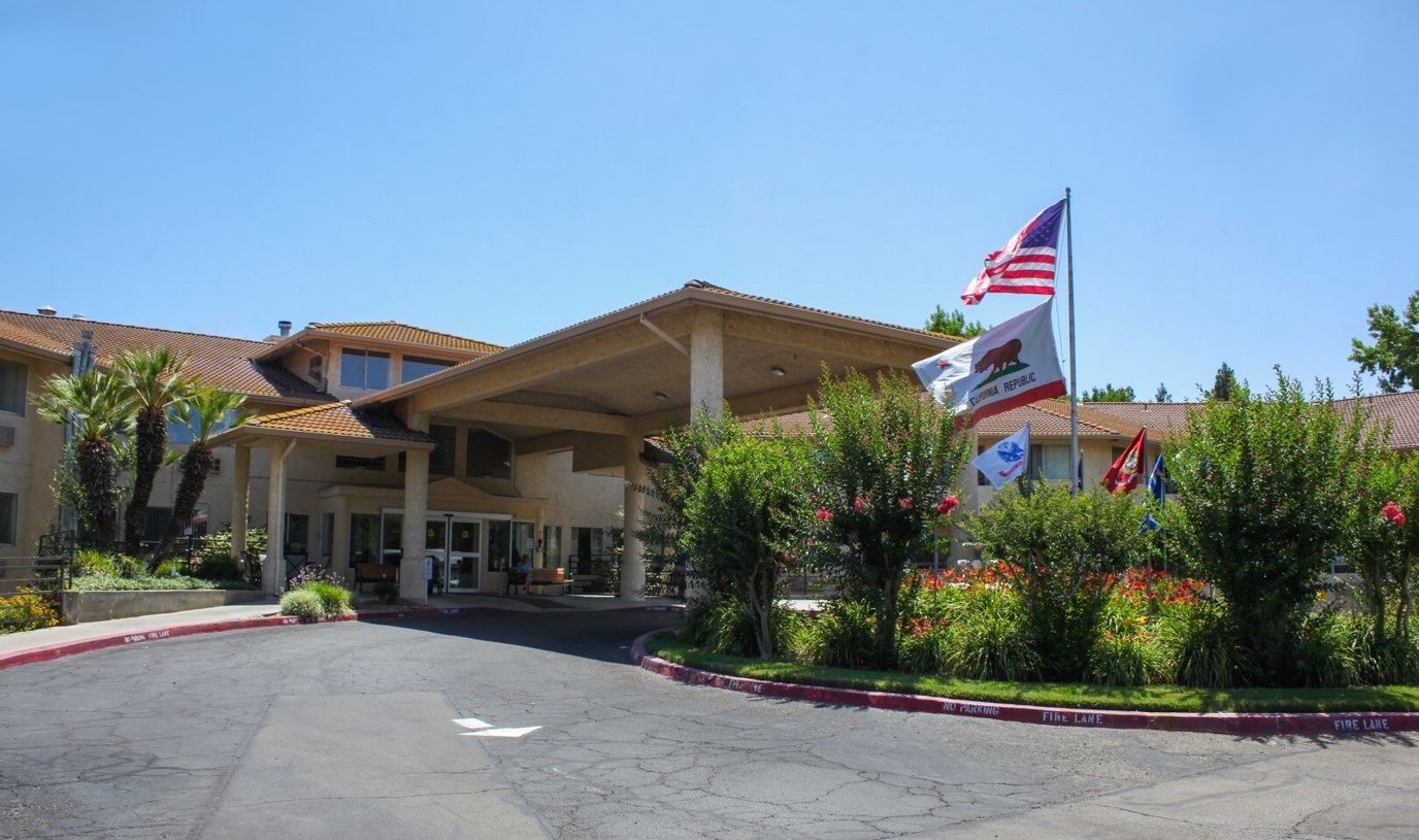 Entrance of Truewood by Merrill facility with flags