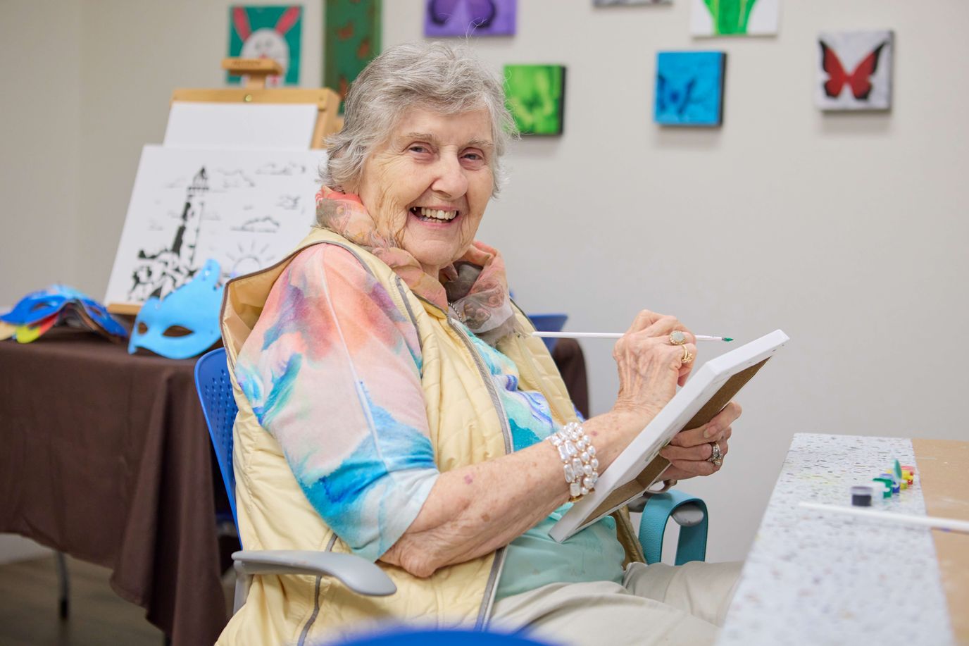Senior resident painting in an activity room