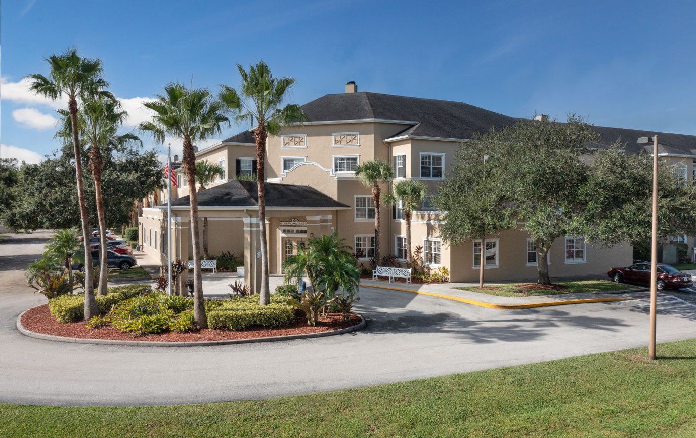 Exterior view of Glenbrooke at Palm Bay with palm trees