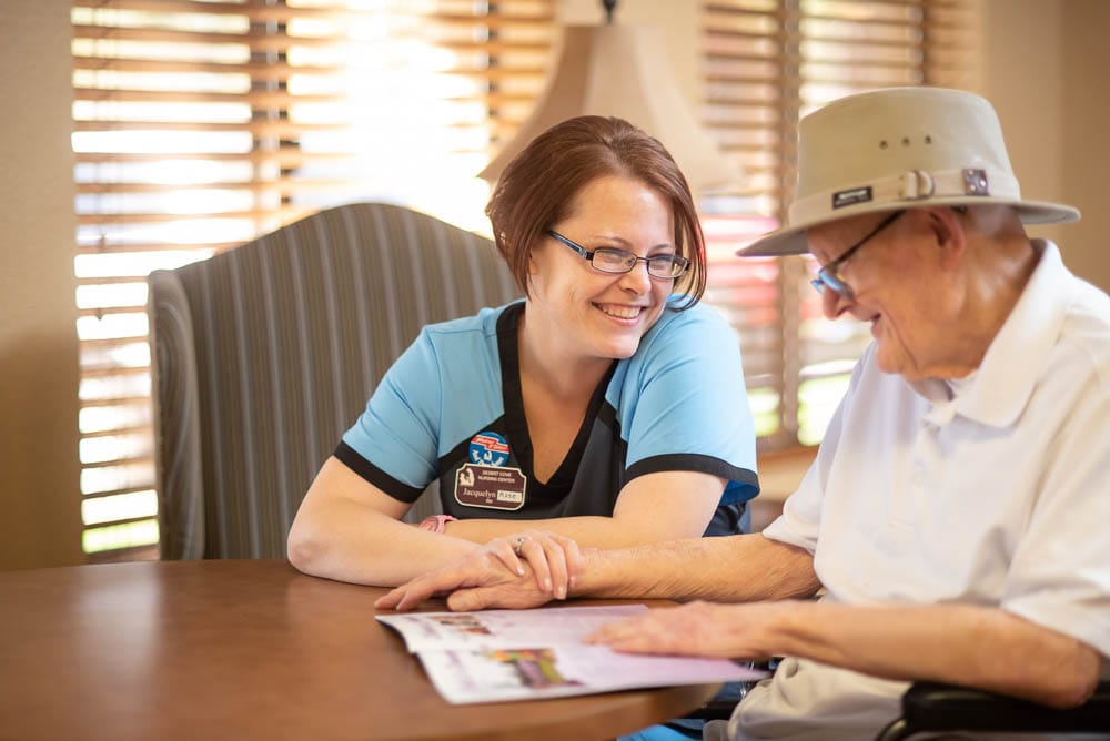 Staff member engaging with a resident at a table