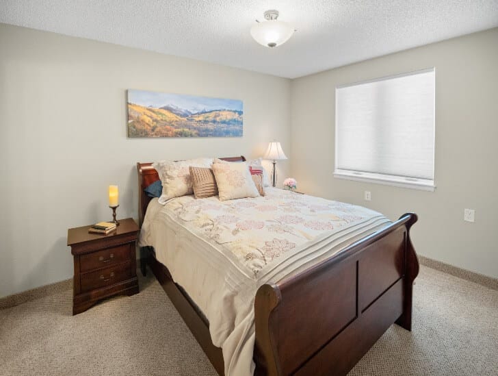 Cozy resident bedroom with lamp and artwork