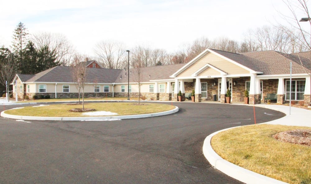 Exterior view of a senior living facility with landscaped entrance