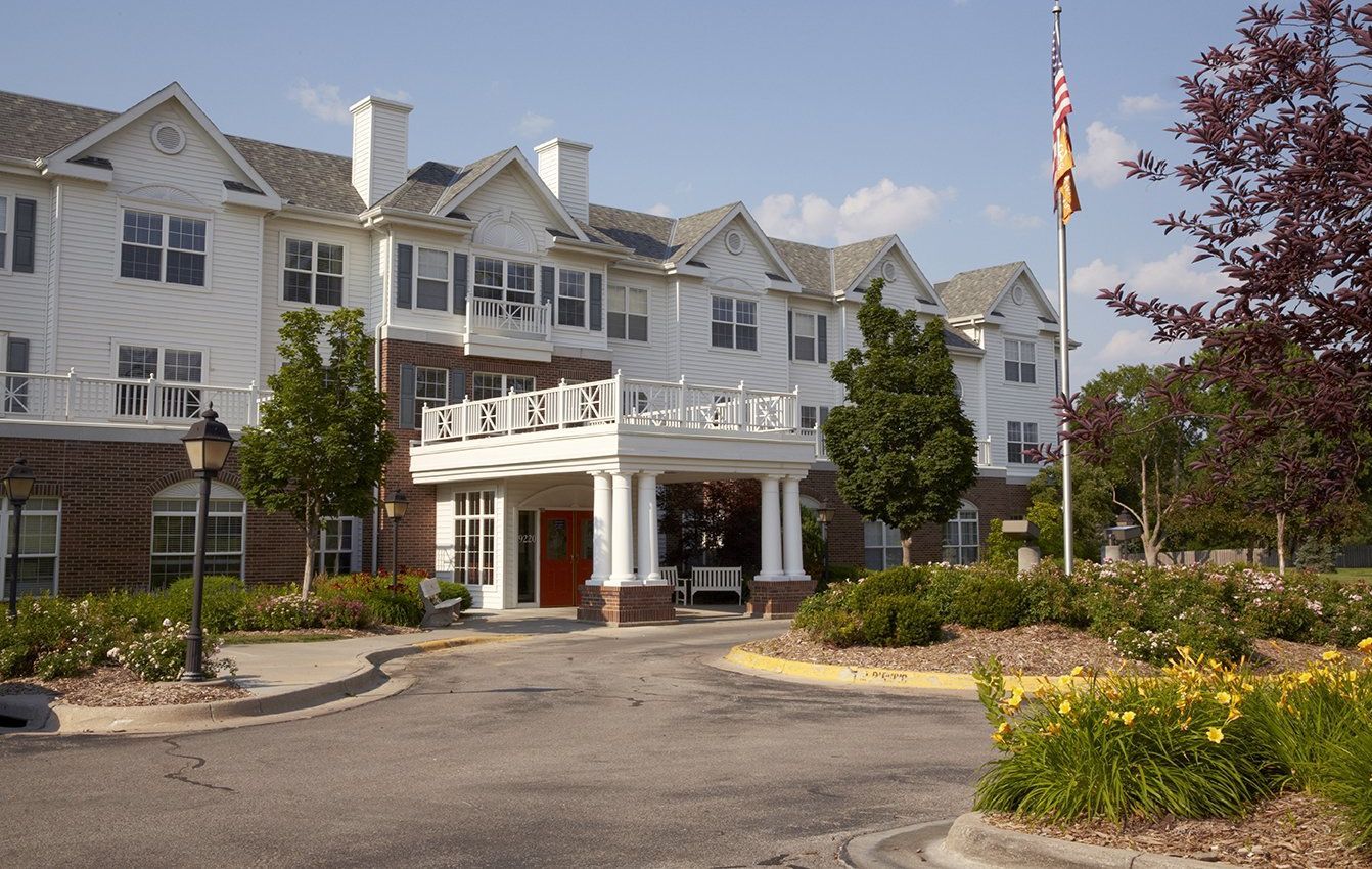 Exterior view of a senior living facility with landscaping
