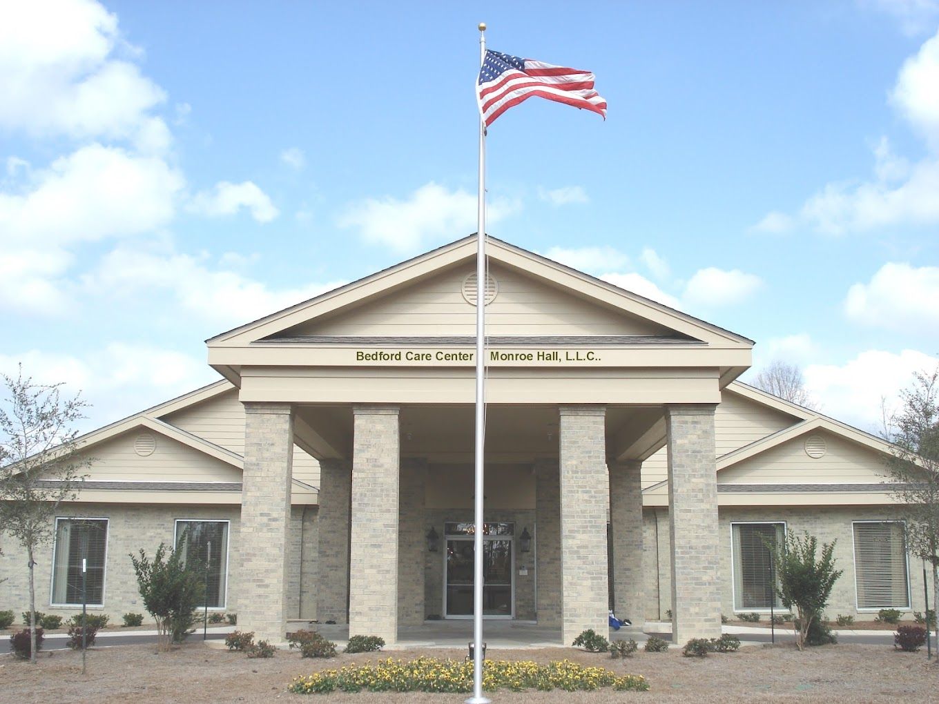 Exterior view of Bedford Care Center with American flag