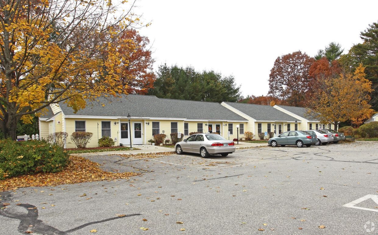 Exterior view of assisted living facility with autumn foliage
