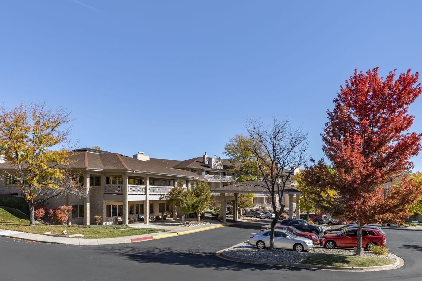 Exterior view of a senior living facility with fall colors