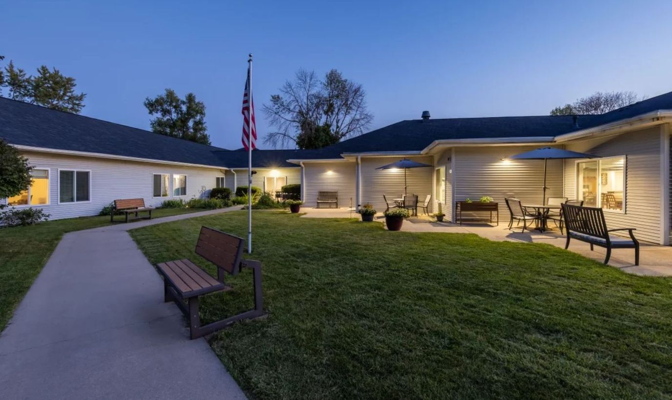 Outdoor seating area with American flag at sunset