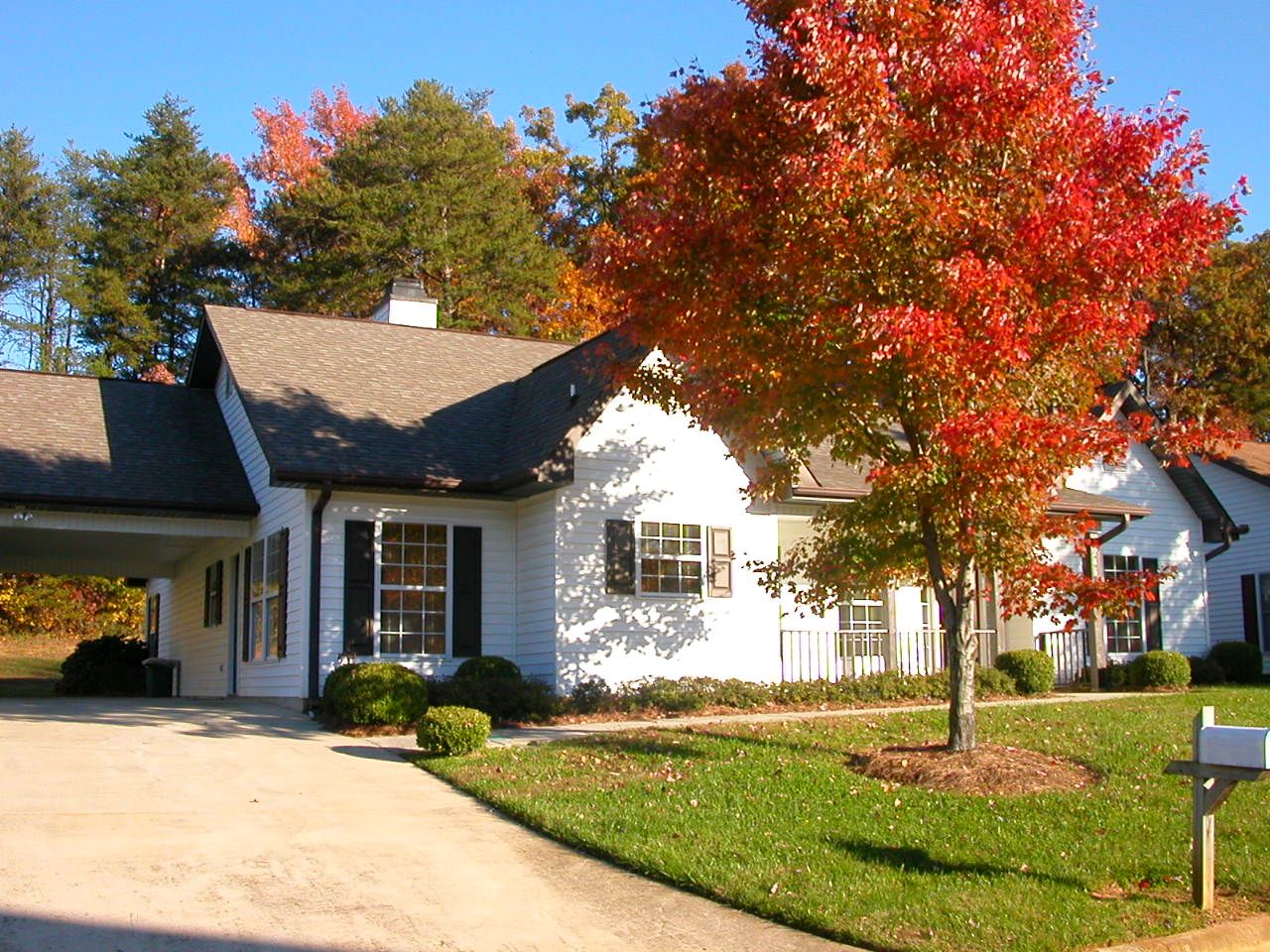 Exterior view of a cozy assisted living facility with fall colors