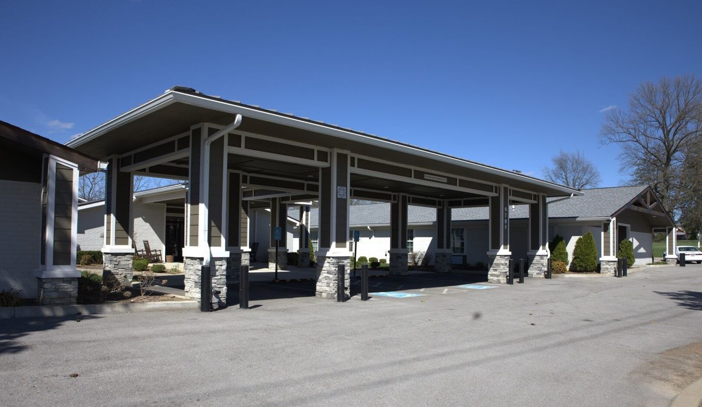 Building exterior with covered entrance and parking area