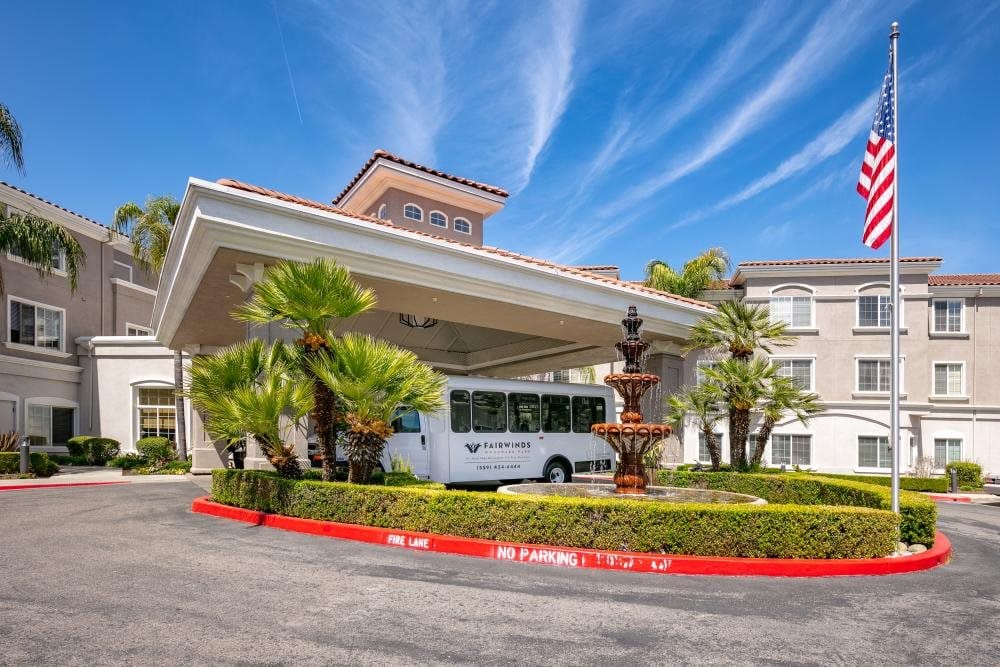 Entrance of Fairwinds Woodwark Park with fountain and shuttle bus