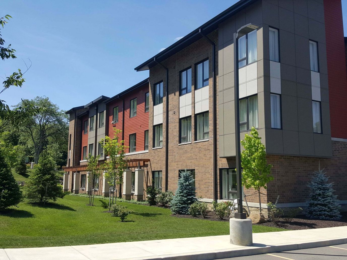 Exterior view of a senior living building with landscaping