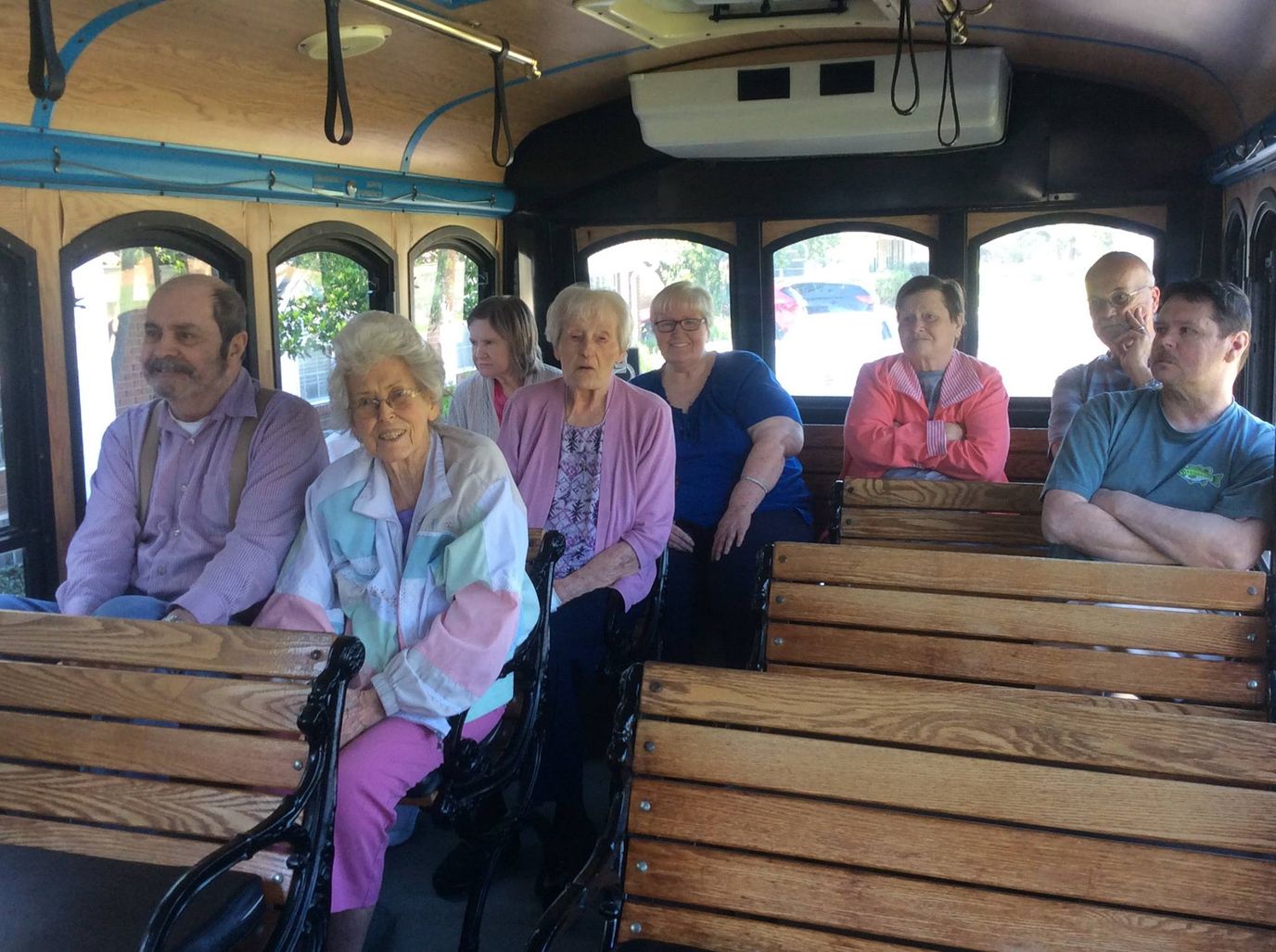Residents enjoying a ride on a facility vehicle