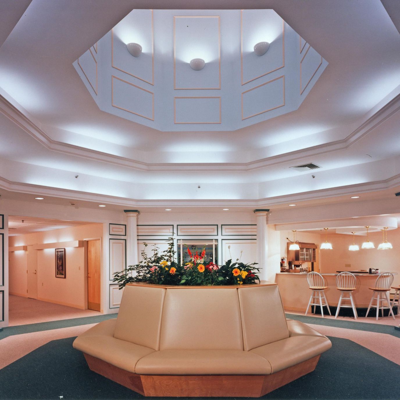 Welcoming lobby with a flower arrangement and seating area.