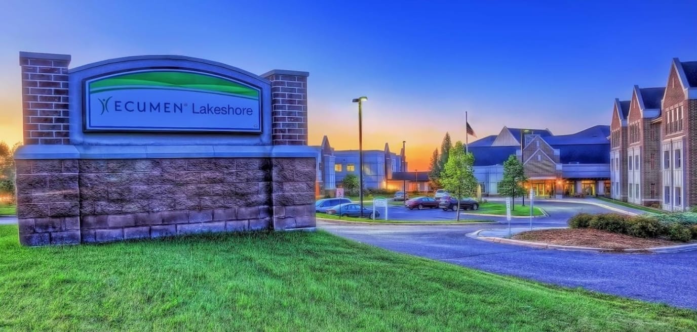 Facility logo and entrance sign at sunset
