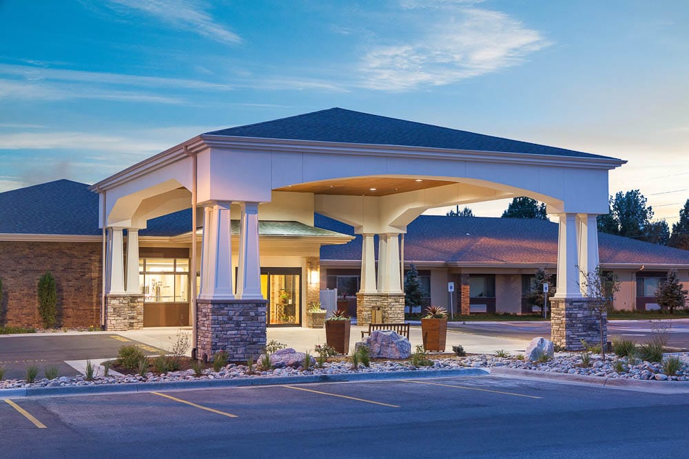 Front entrance of a senior living facility with a covered entrance