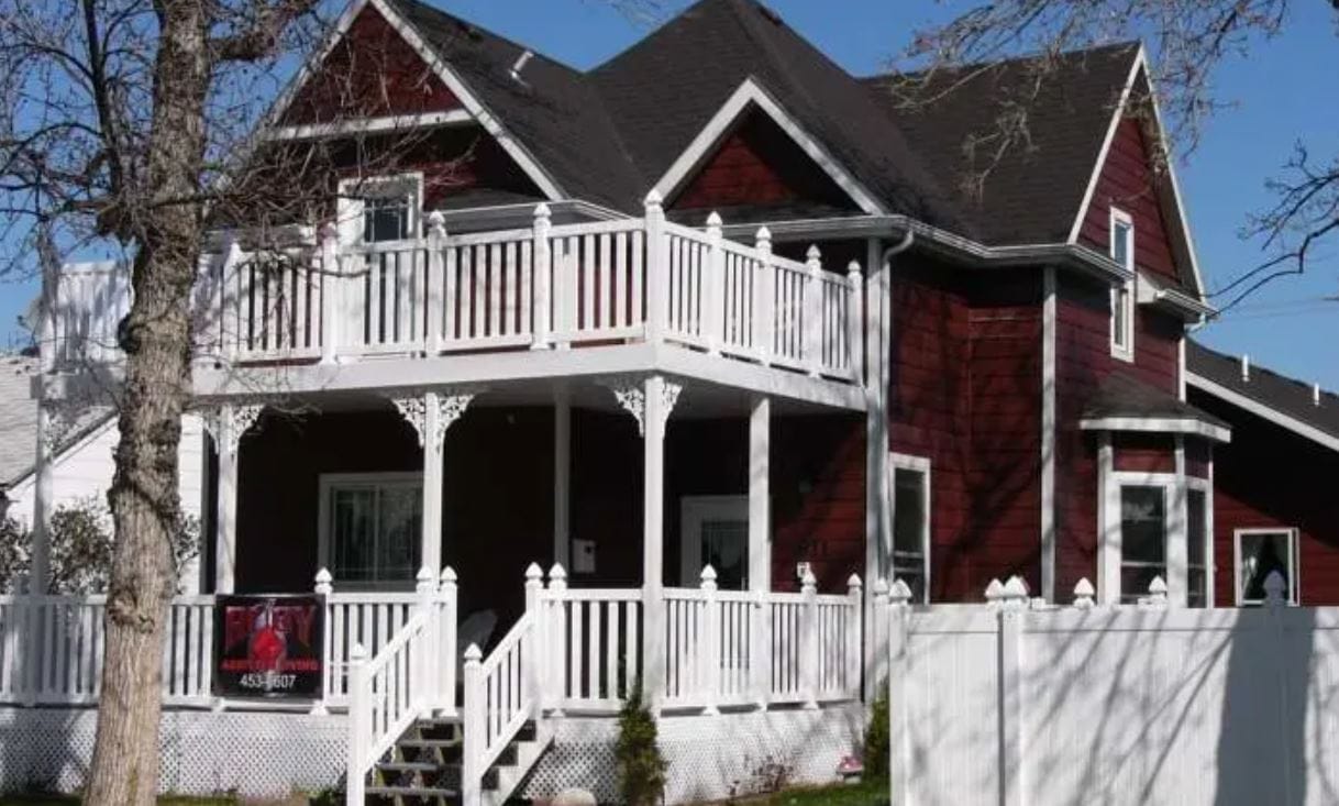 Exterior view of a red house with a porch